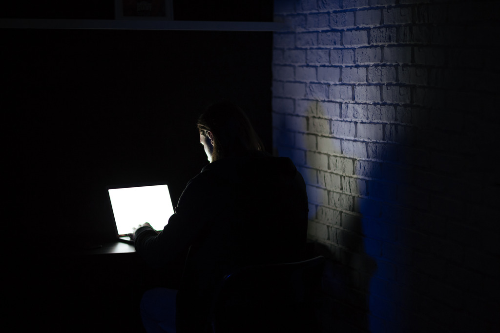 back view young concentrated man using laptop 1